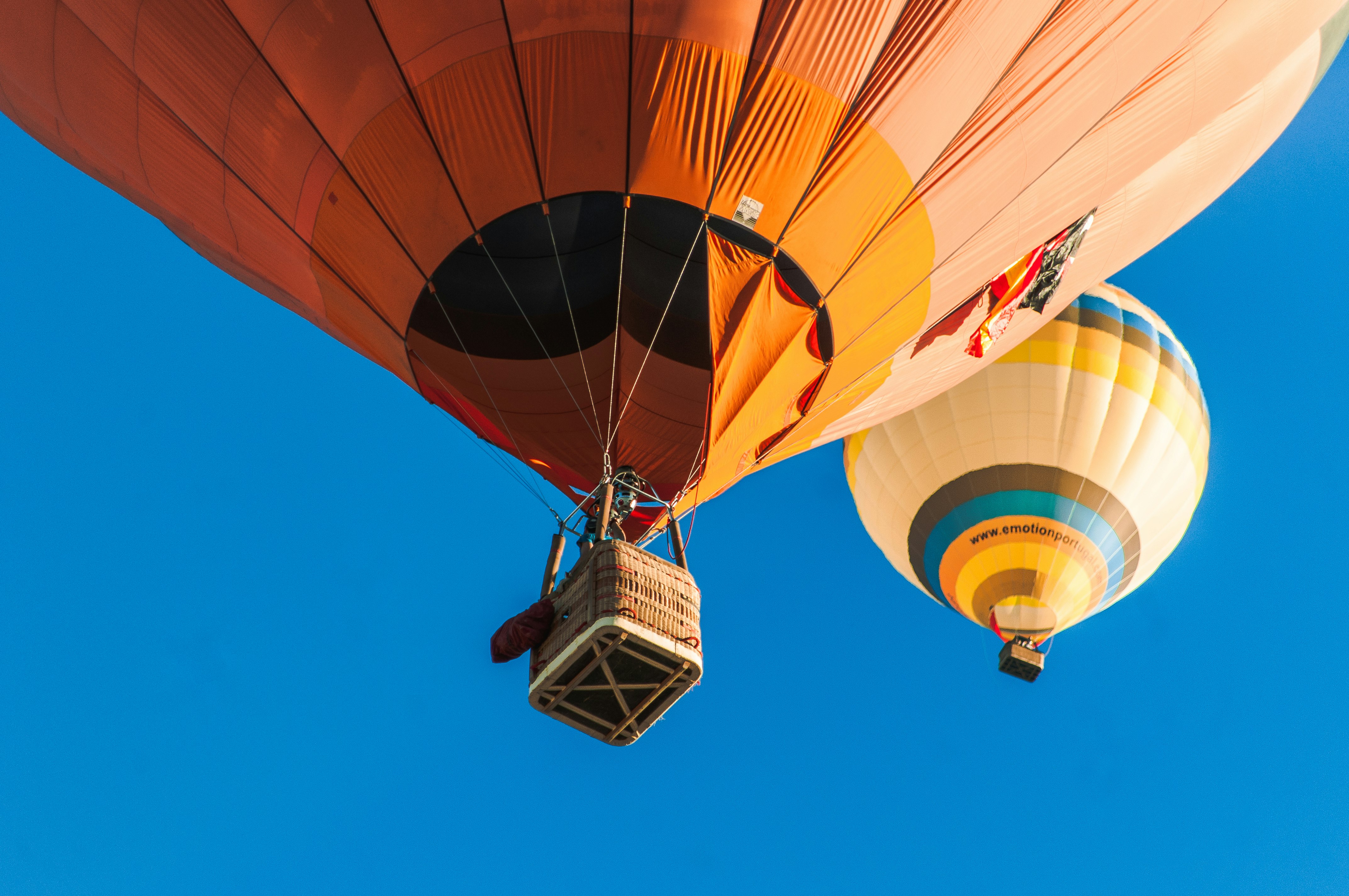 two hot air balloons in the sky during daytime